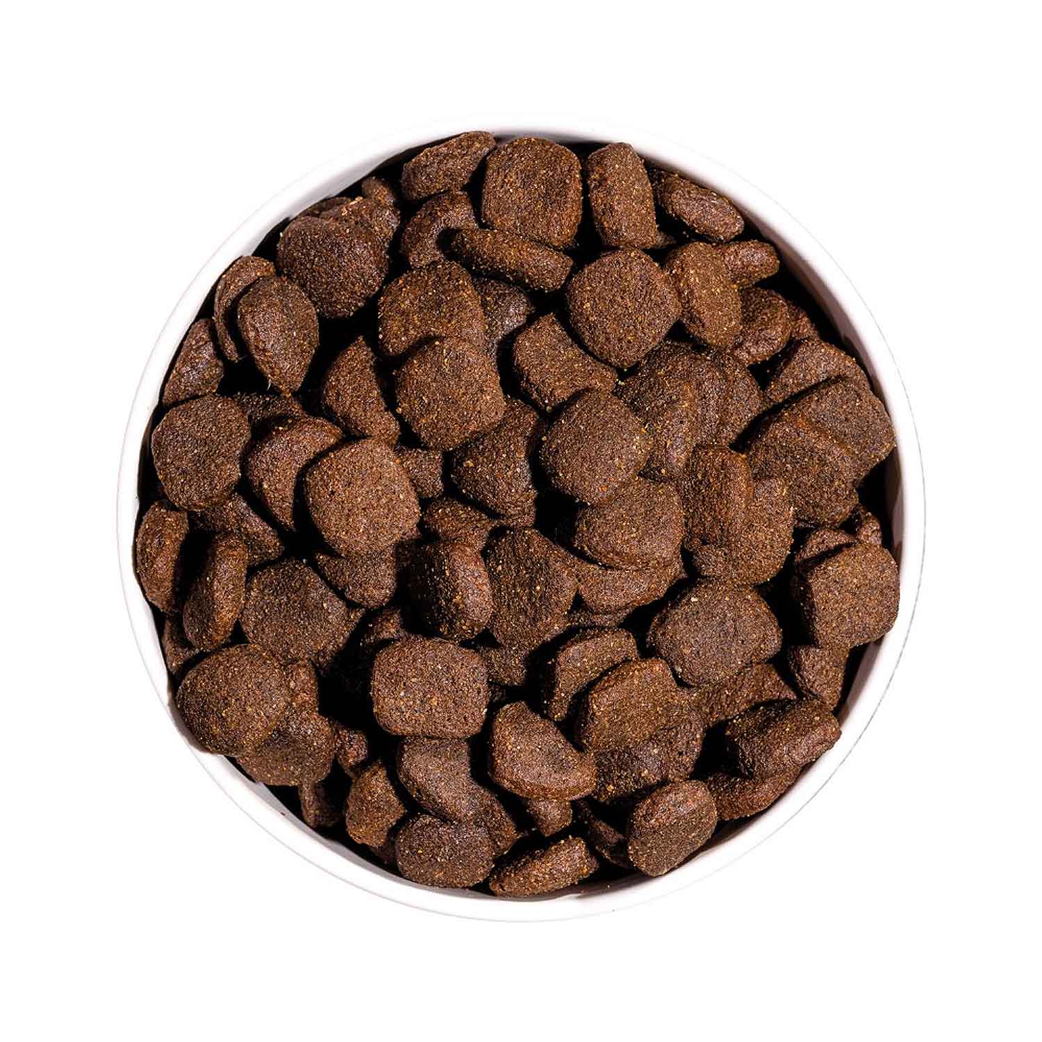 Vista superior de un cuenco lleno de croquetas del pienso Ownat Grain Free Prime Adult Chicken & Turkey, alimento seco natural para perros adultos sin cereales.